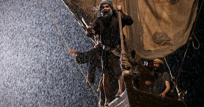 Yeshu's followers standing in a boat, afraid of a storm at sea